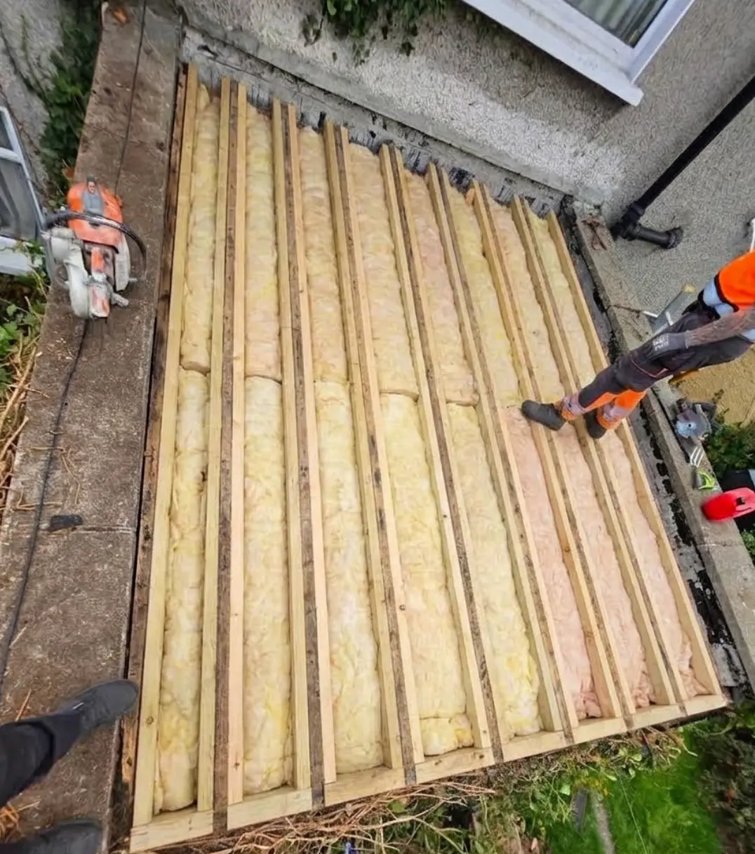 New insulation laid between timbers on a small flat roof