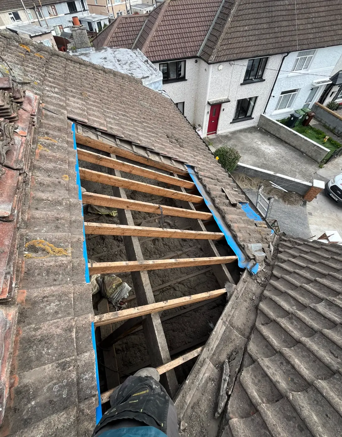 Pitched roof stripped back to exposed timber framing during repairs